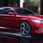 Red Honda Accord driving through city streets
