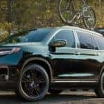 family on trail near black honda pilot