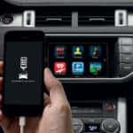 Land Rover InControl on smartphone and touchscreen inside of SUV