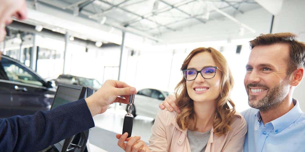 Couple getting keys to car