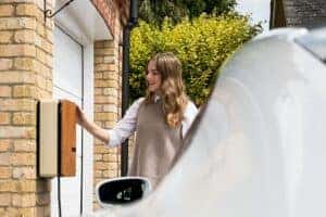 woman charging an electric vehicle