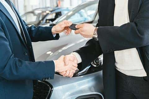 person trading in a car at a Boucher Auto Group dealership