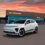 white 2025 Hyundai Kona electric SUV parked at a Boucher Auto Group dealership