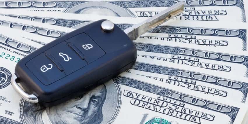 Car key on a fan of cash