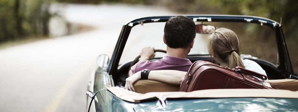 Couple driving in a convertible