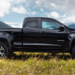 Black Chevy Colorado parked on grass