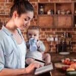 Person holding a baby shopping on a tablet
