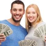 Smiling people holding cash