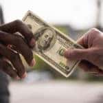 Hands passing cash