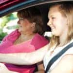 A teen driver practicing driving with her mom