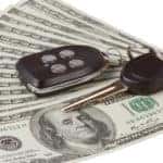 Car keys on a fan of cash