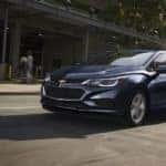 A blue used 2017 Chevy Cruse drives a Columbus Ohio street