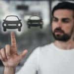 An out of focus man is virtually selecting a car instead of doing a buy here, pay here in Indianapolis, IN.
