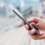 A close up of a hand holding a phone is shown in Columbus, Ohio.