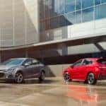 A 2019 Chevy Cruze and the Cruze hatchback are shown parked in front of a office building near a dealership who helps with bad credit car finance Indianapolis, IN.