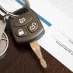 Car keys are shown next to an application for no credit car loans in Columbus.