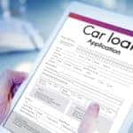 A man is looking at a car loan to decide what is better for him, a Buy Here Pay Here vs traditional Loan in Indianapolis, IN.