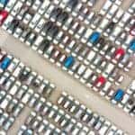 A birds eye view of cars at a dealership.
