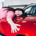 After searching 'what type of credit score to get a car near Columbus', a woman is hugging the car of her dreams.
