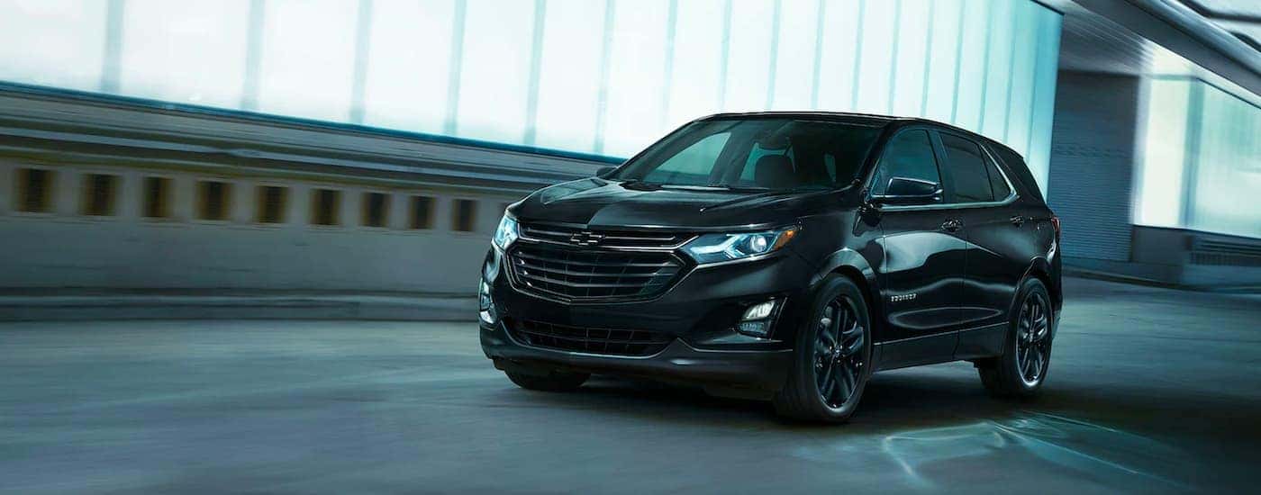 A black 2020 Chevy Equinox Midnight Edition is shown driving in a tunnel.