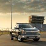 A 2014 Chevy Silverado 1500 LTZ Texas Edition is shown parked in front of a football field.