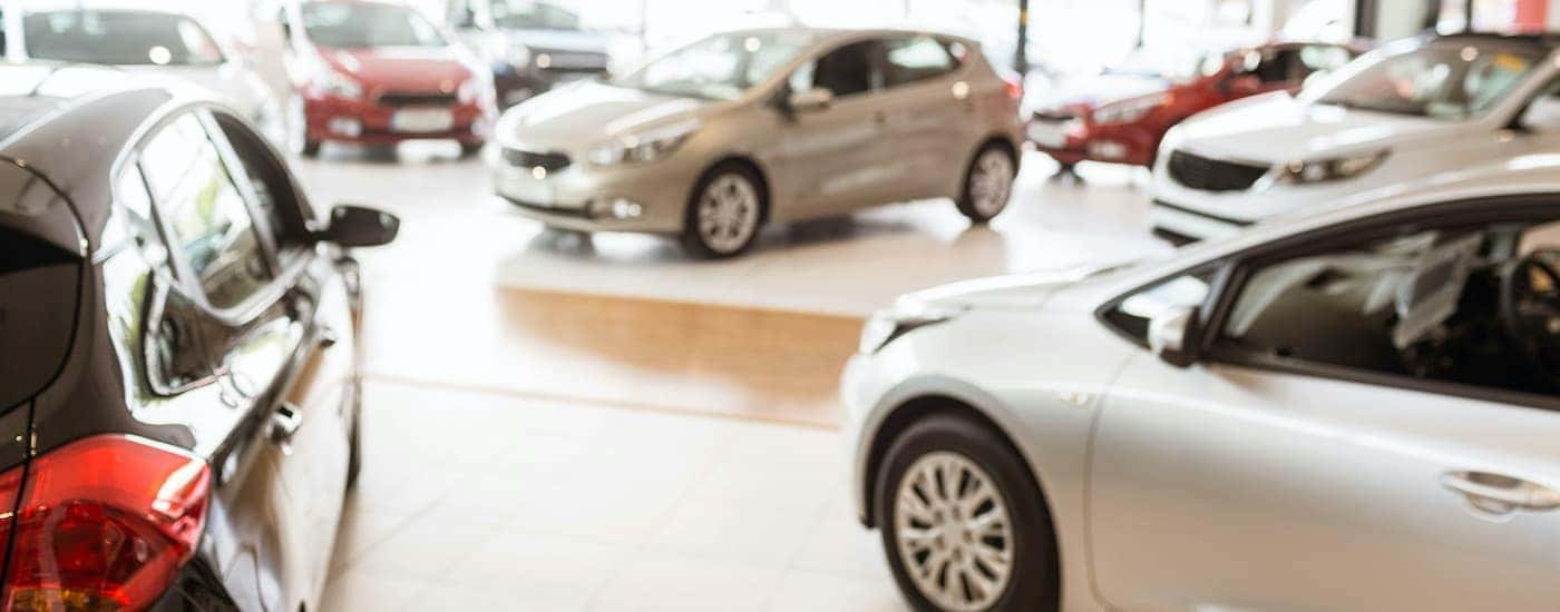 The interior of a used car lot in Indianapolis shows cars parked at an angle.