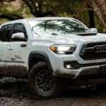 A white 2020 Toyota Tacoma TRD is shown offroading after leaving a dealership specializing in Indianapolis online car sales.