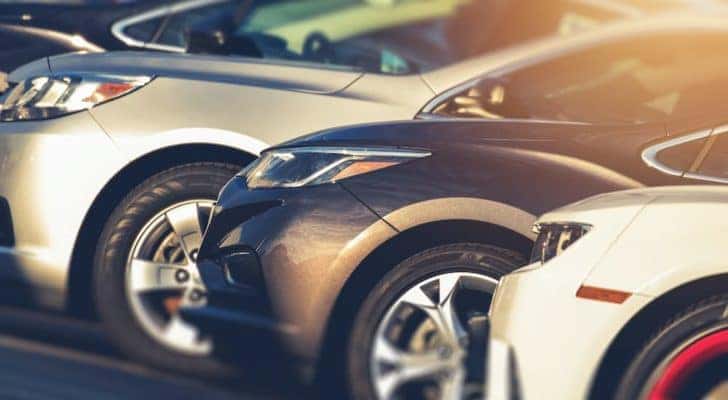 A row of cars are shown parked in a lot for Columbus online car sales.