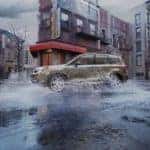 One of the most popular vehicles in the Dublin OH online car sales, a light green 2017 Subaru Forester is shown splashing through a puddle.