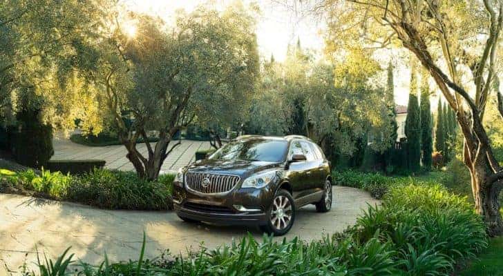 A black 2016 Buick Enclave Tuscan Edition is shown traveling up a winding driveway.