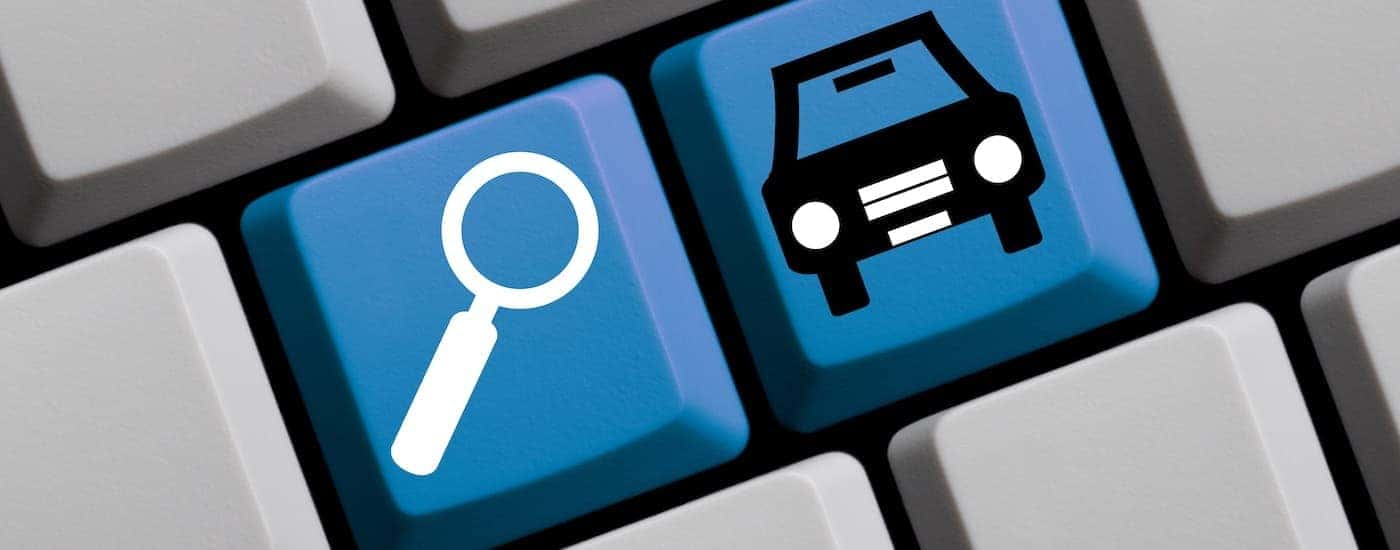 A keyboard shows a search icon and a car icon.