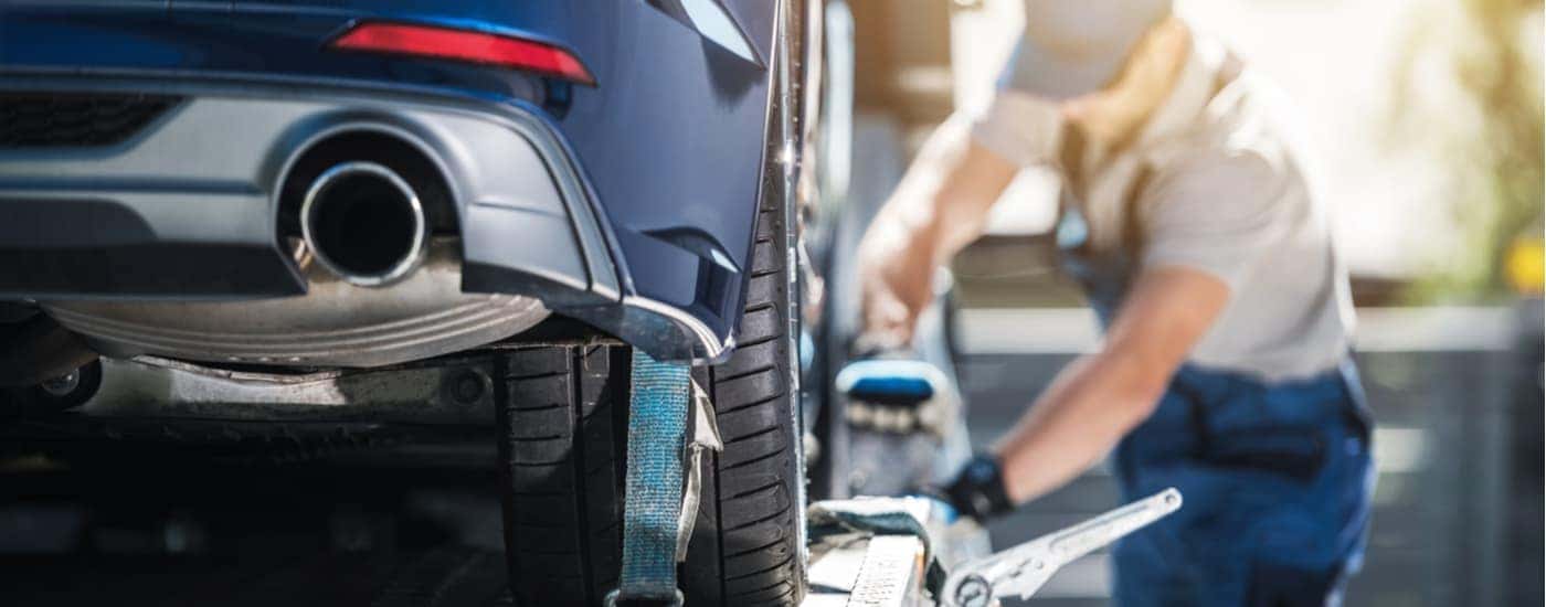 A person is shown preparing a vehicle for delivery.