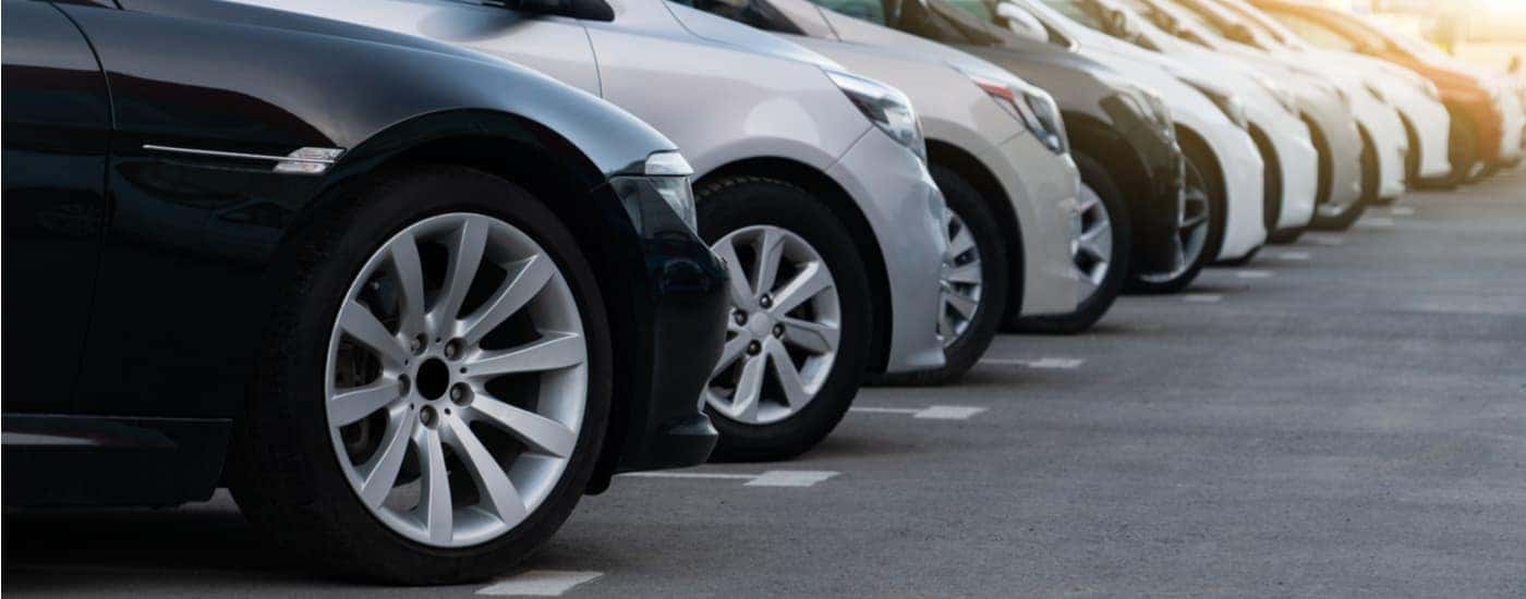 A row of used vehicles is shown at a Shively online car dealership lot.