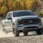 A silver 2021 Ford F-150 Tremor is shown on a dirt path after leaving an Houston online car sales dealer.