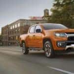 An orange 2021 Chevy Colorado is shown from the front.