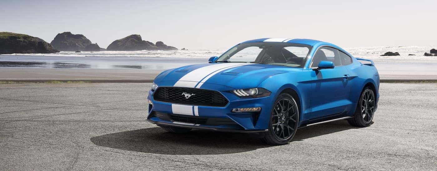 A popular vehicle for Seattle online car sales, a blue 2019 Ford Mustang EcoBoost, is shown on the coast.