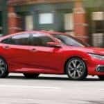 A red 2020 Honda Civic Touring is shown from the side after leaving a dealer that handles online Honda Civic sales.