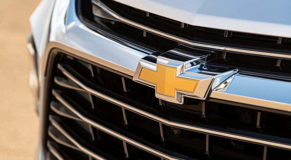 A close up shows the grille and badge on a silver 2020 Chevy Blazer.