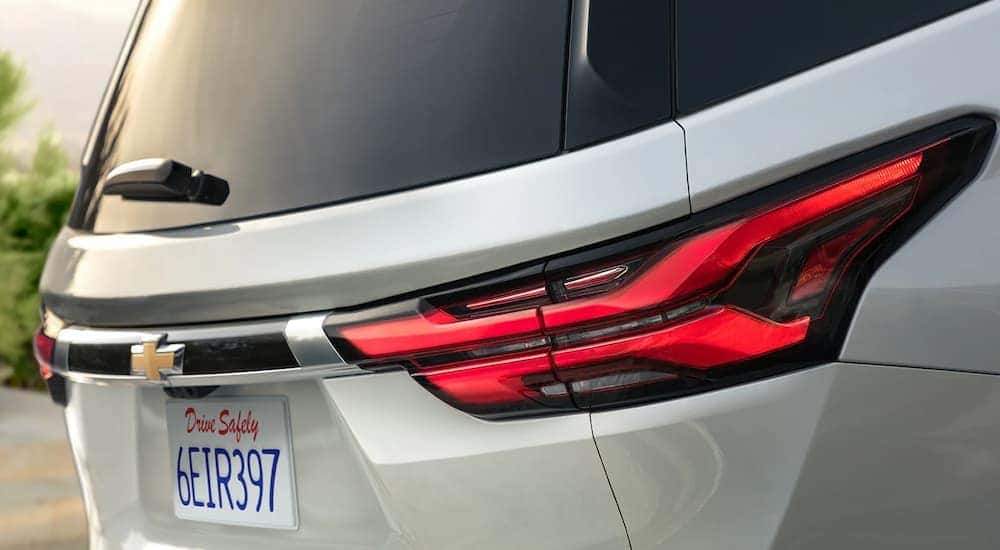 A close up of the rear taillight on a grey 2023 Chevy Traverse is shown.