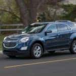 A blue 2016 Chevy Equinox is shown from the side after visiting some Car dealers that deal with bankruptcies.