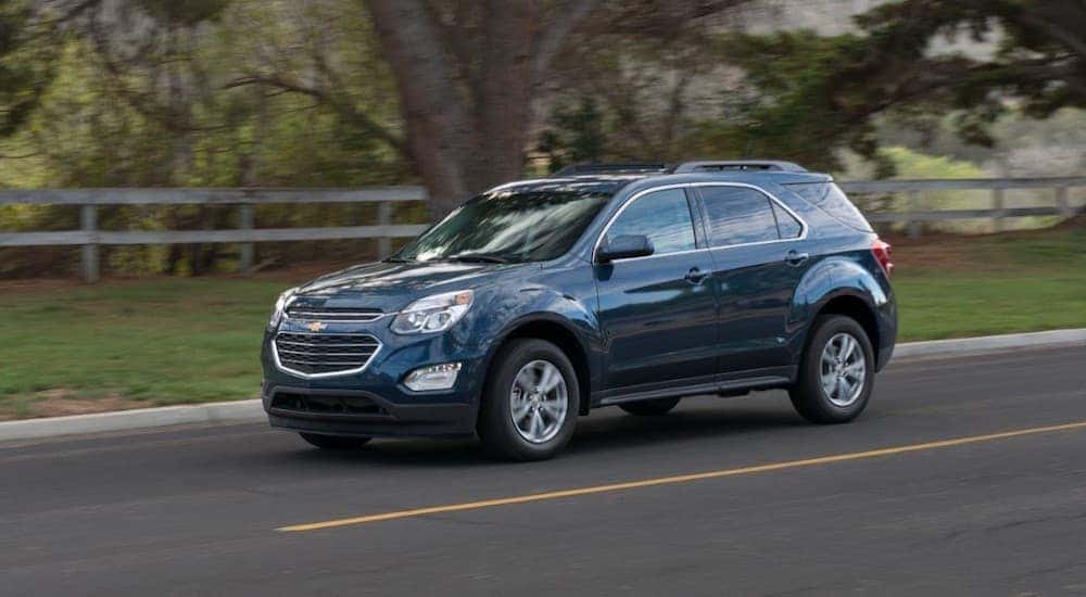 A blue 2016 Chevy Equinox is shown from the side after visiting some Car dealers that deal with bankruptcies.