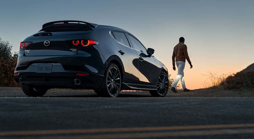 A black 2022 Mazda3 is shown from the rear at an angle after leavign a dealer that handles Detroit car sales.