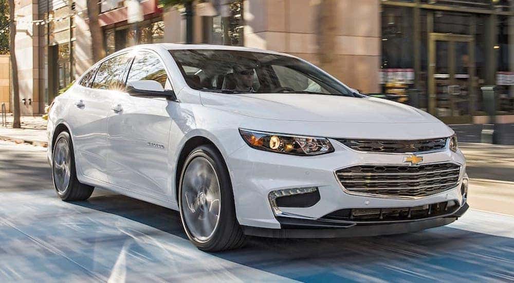 A white 2016 Chevy Malibu is shown from the front at an angle after leaving a dealer that handles Memphis car sales.