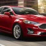 A red 2020 Ford Fusion is shown from the front at an angle after leaving a dealer that handles St. Louis car sales.