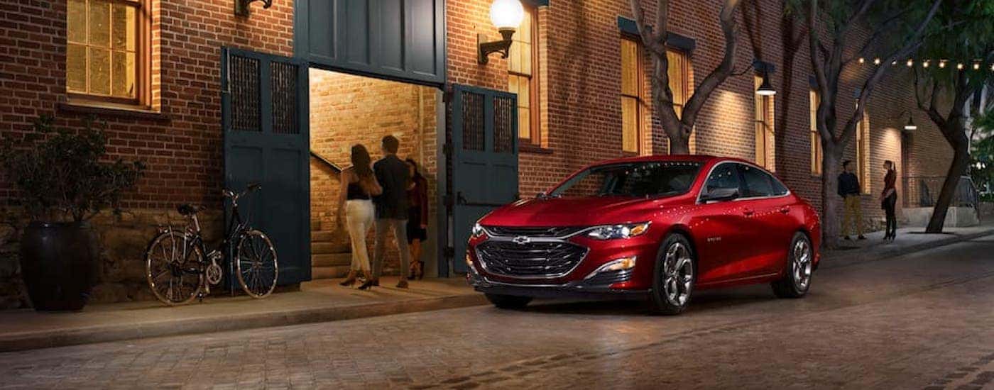 A red 2019 Chevy Malibu RS is shown from the front at an angle after leaving a dealer that handles Kansas City car sales.