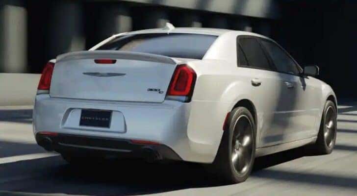 A white 2023 Chrysler 300C is shown from the rear at an angle.