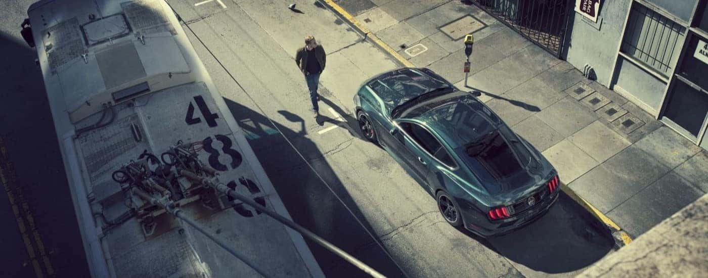 A green 2020 Ford Mustang BULLITT is shown from a high angle on a city street.