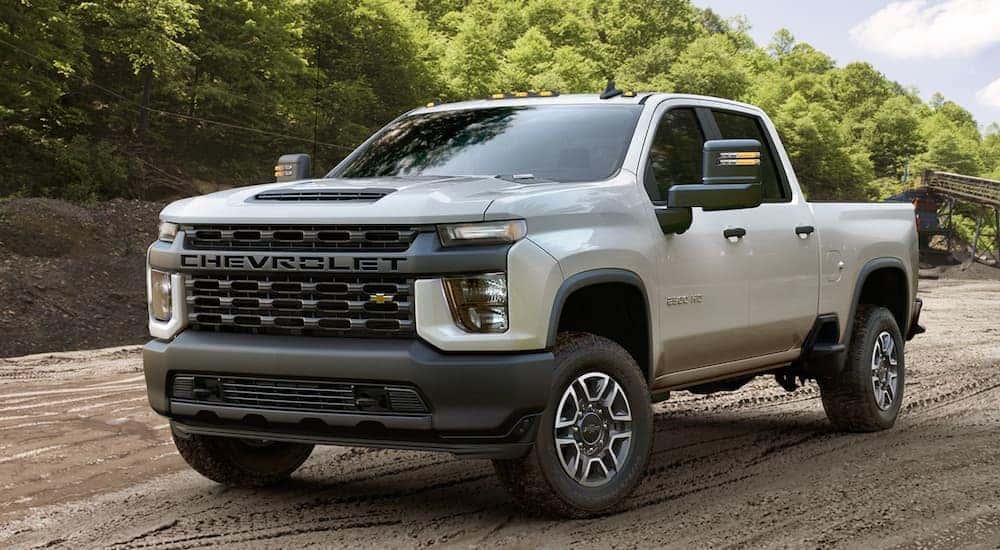 A white 2020 Chevy Silverado 2500 HD is shown from the front at an angle after leaving a dealer that handles Charlotte car sales.