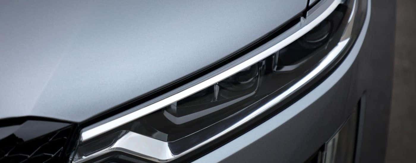 A close up shows the driver side headlight on a silver 2020 Cadillac XT6 Sport.