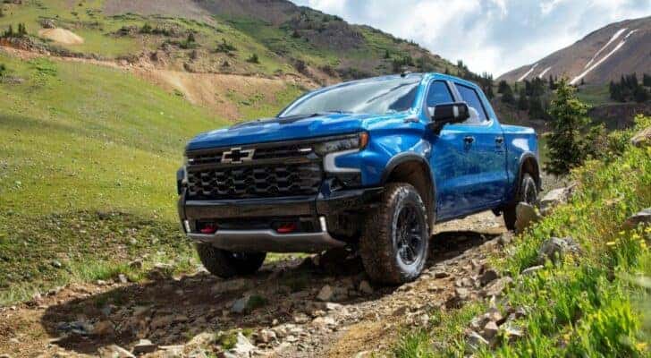 A blue 2022 Chevy Silverado ZR2 is shown on a trail after looking at cars for sale in Little Rock,